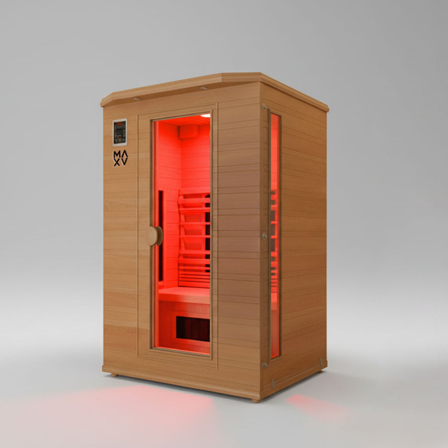 Wooden infrared sauna with red interior light on a gray background